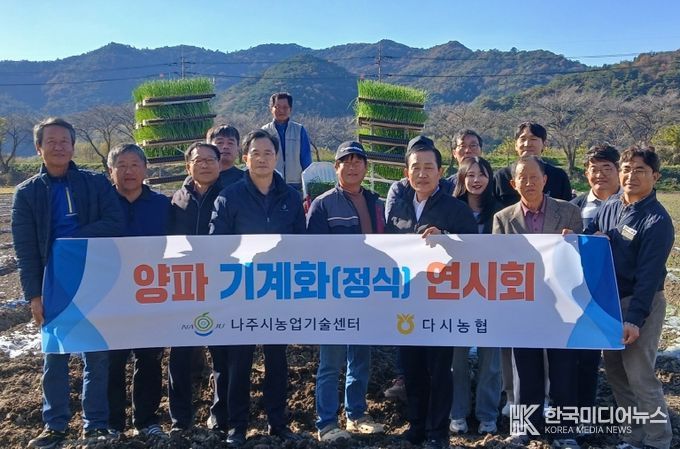 양파 기계 정식 연시회에 참가한 농업인들과 관계자들이 기념촬영을 하고 있다.