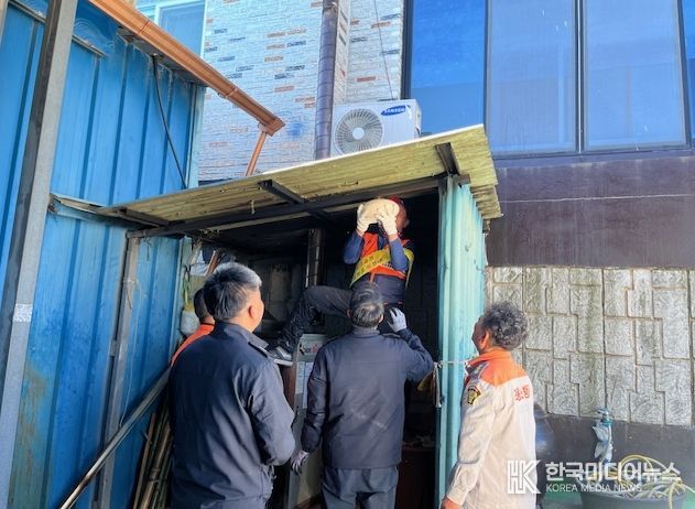 장흥소방서가 화목보일러실 천장에 자동확산소화기를 설치하고 있다.